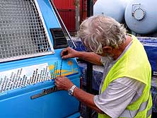 Lae/Papua New Guinea: Before leaving the port, Emil adds our 167th sticker: 'Papua New Guinea'